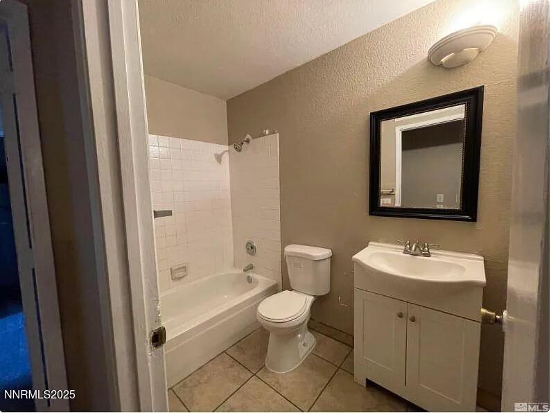 2375 Tripp Drive, Unit 9 Reno, NV 89512 - Photo 7 of 10 a bathroom with a toilet sink and mirror