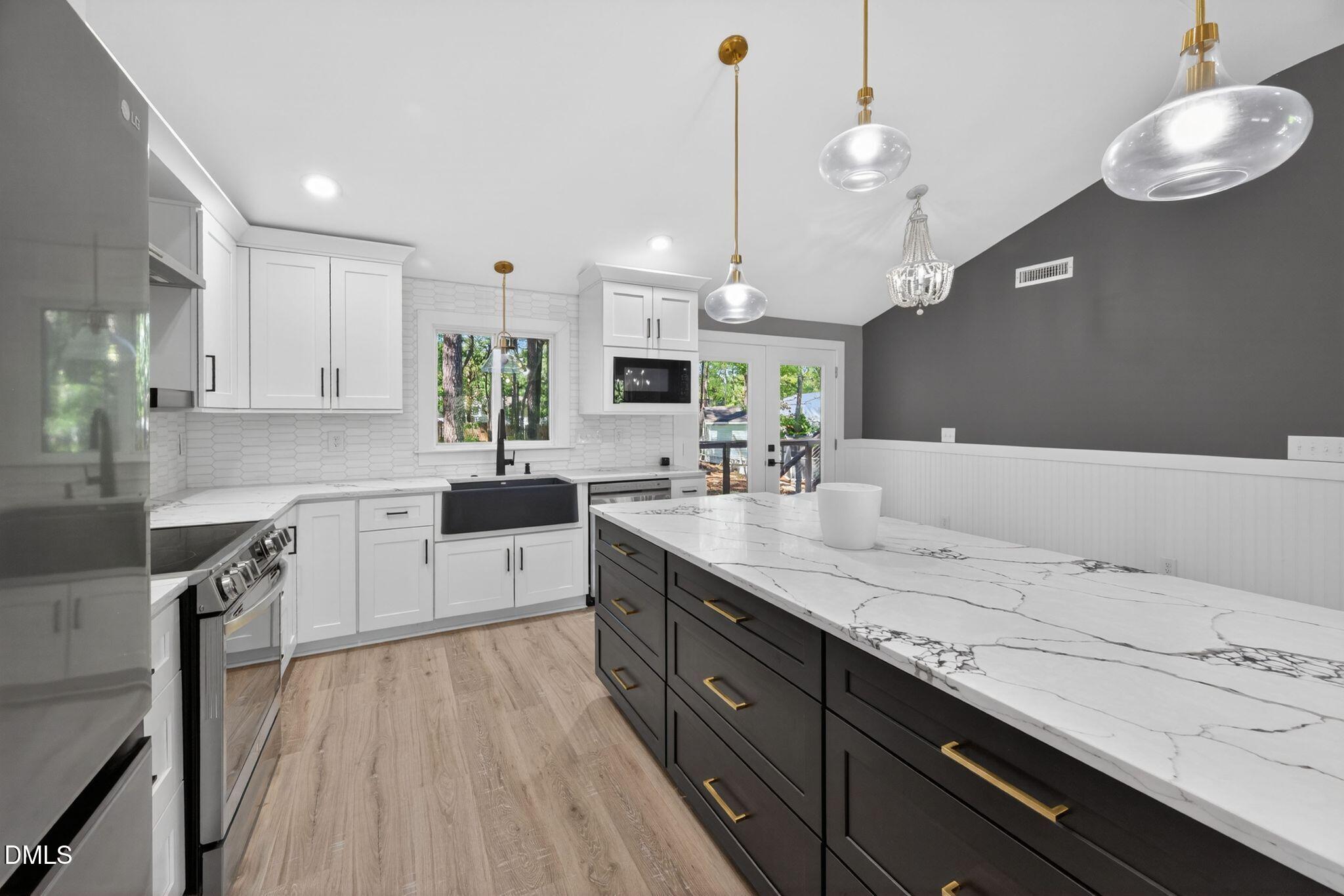 313 Crown Oaks Drive Raleigh, NC 27615 - Photo 52 of 60 a kitchen with a sink a counter space appliances and cabinets
