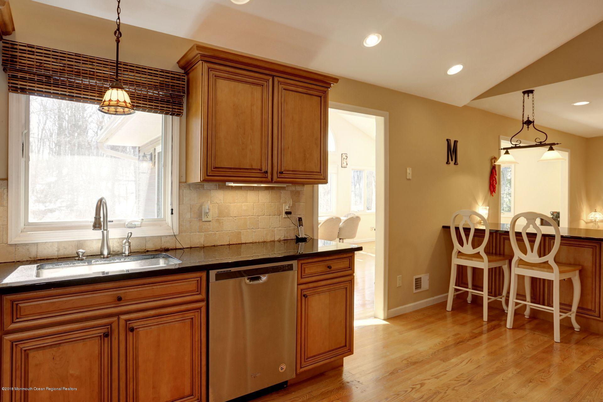 115 Crawford Road Middletown, NJ 07748 - Photo 14 of 41 a kitchen with stainless steel appliances granite countertop sink window and dining table