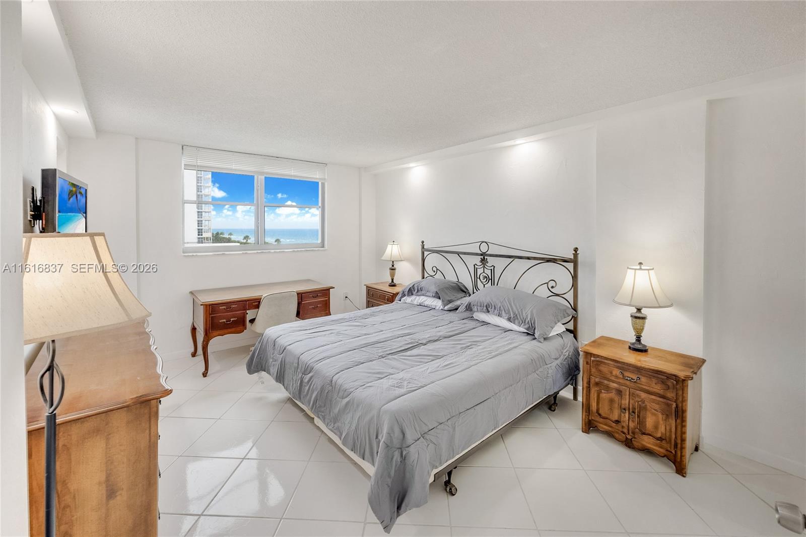 9273 Collins Avenue, Unit 507 Surfside, FL 33154 - Photo 10 of 22 a bedroom with a bed and a table