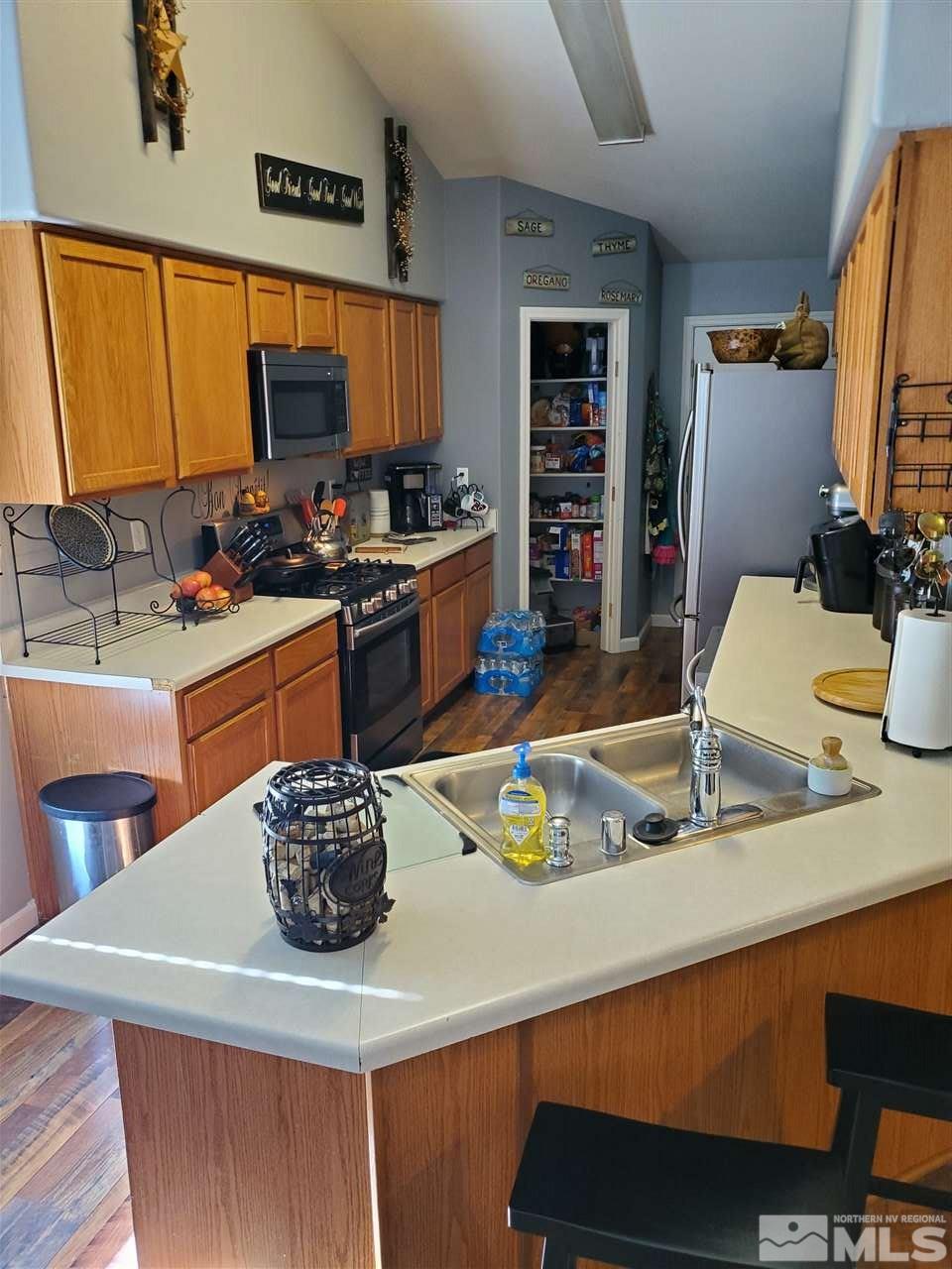1239 Lattin Road Fallon, NV 89406 - Photo 5 of 15 a kitchen with a sink a stove and chairs
