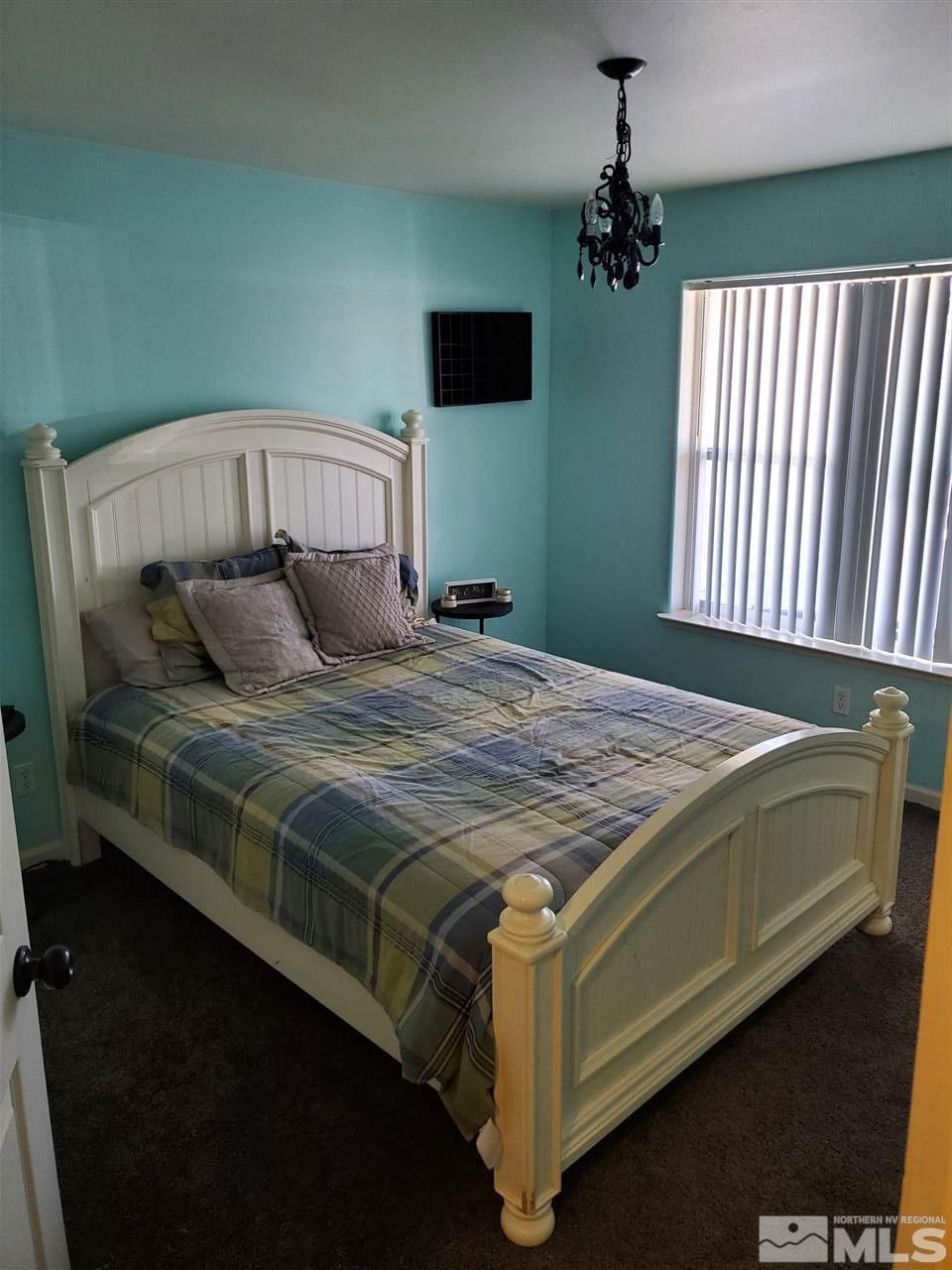 1239 Lattin Road Fallon, NV 89406 - Photo 8 of 15 a bedroom with a bed and a flat tv screen