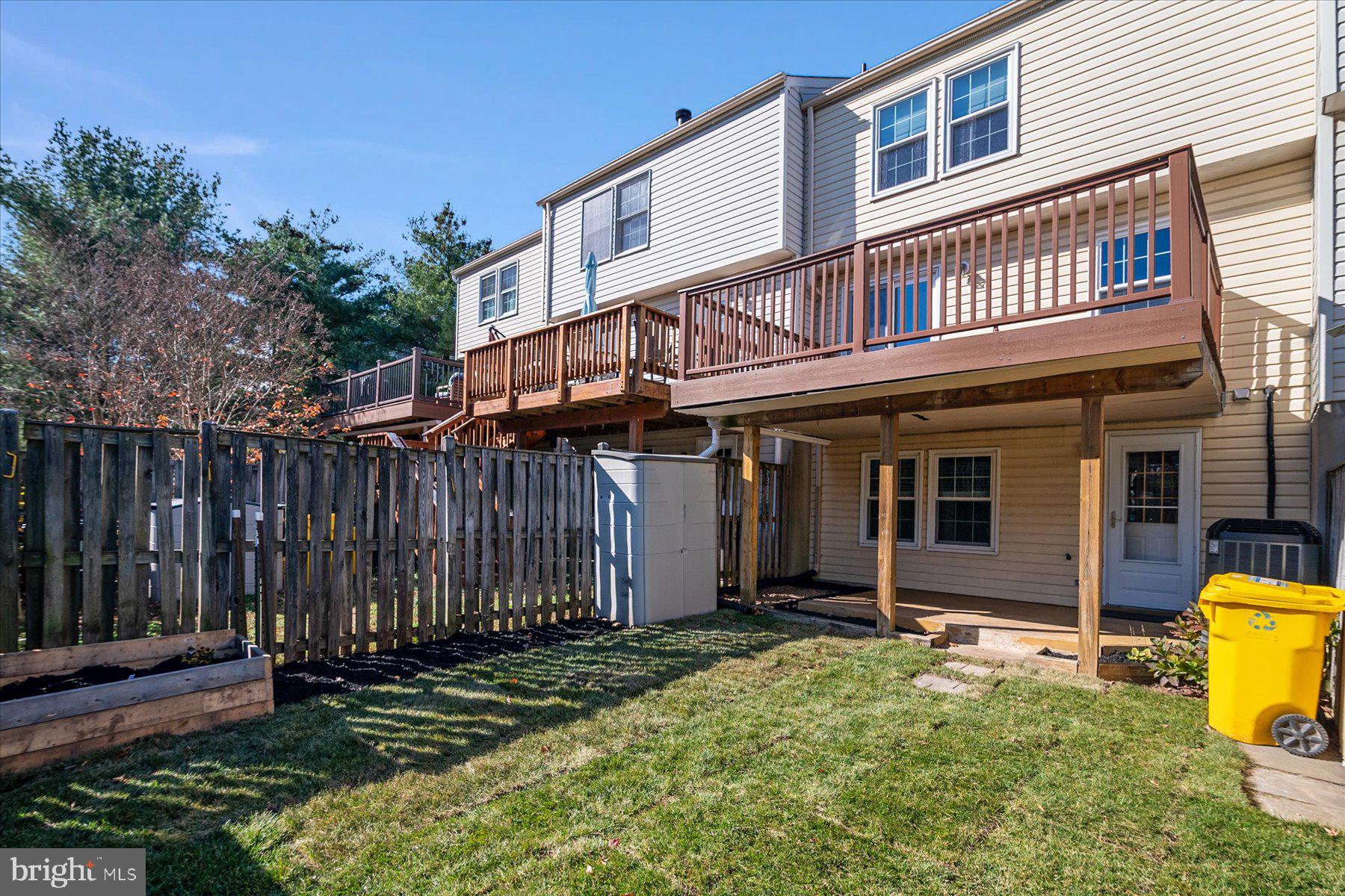 727 Dayspring Drive Odenton, MD 21113 - Photo 36 of 44 a view of a house with a small yard and wooden fence