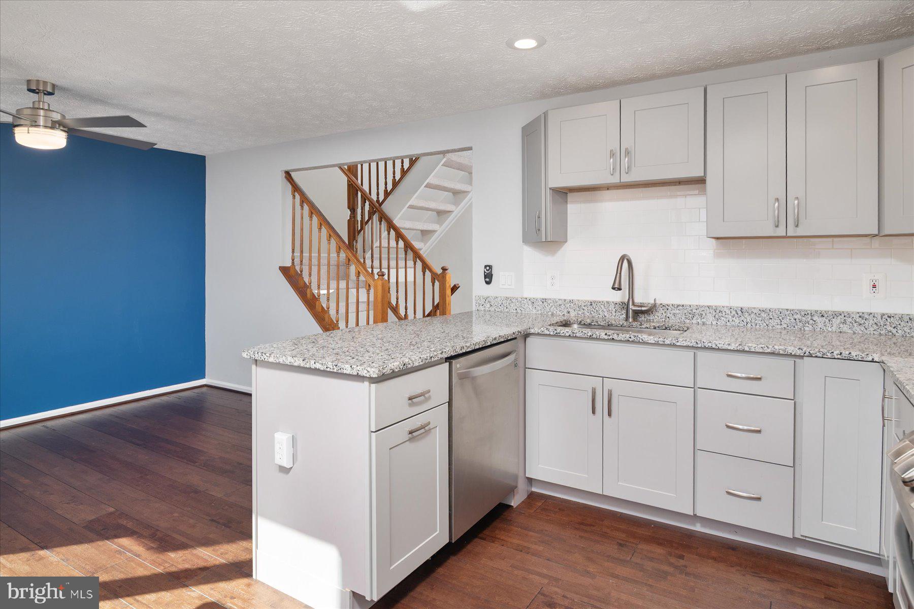 727 Dayspring Drive Odenton, MD 21113 - Photo 8 of 44 a kitchen with granite countertop cabinets stainless steel appliances and a wooden floor