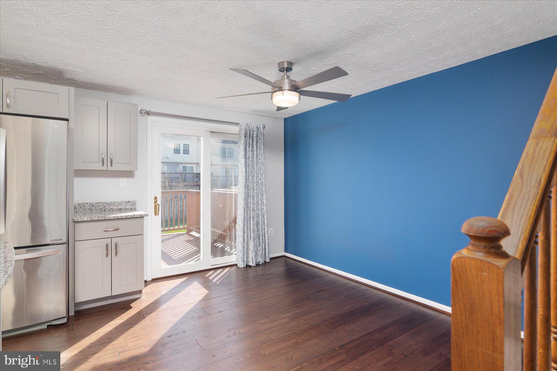 727 Dayspring Drive Odenton, MD 21113 - Photo 9 of 44 a view of a kitchen with wooden floor and a refrigerator