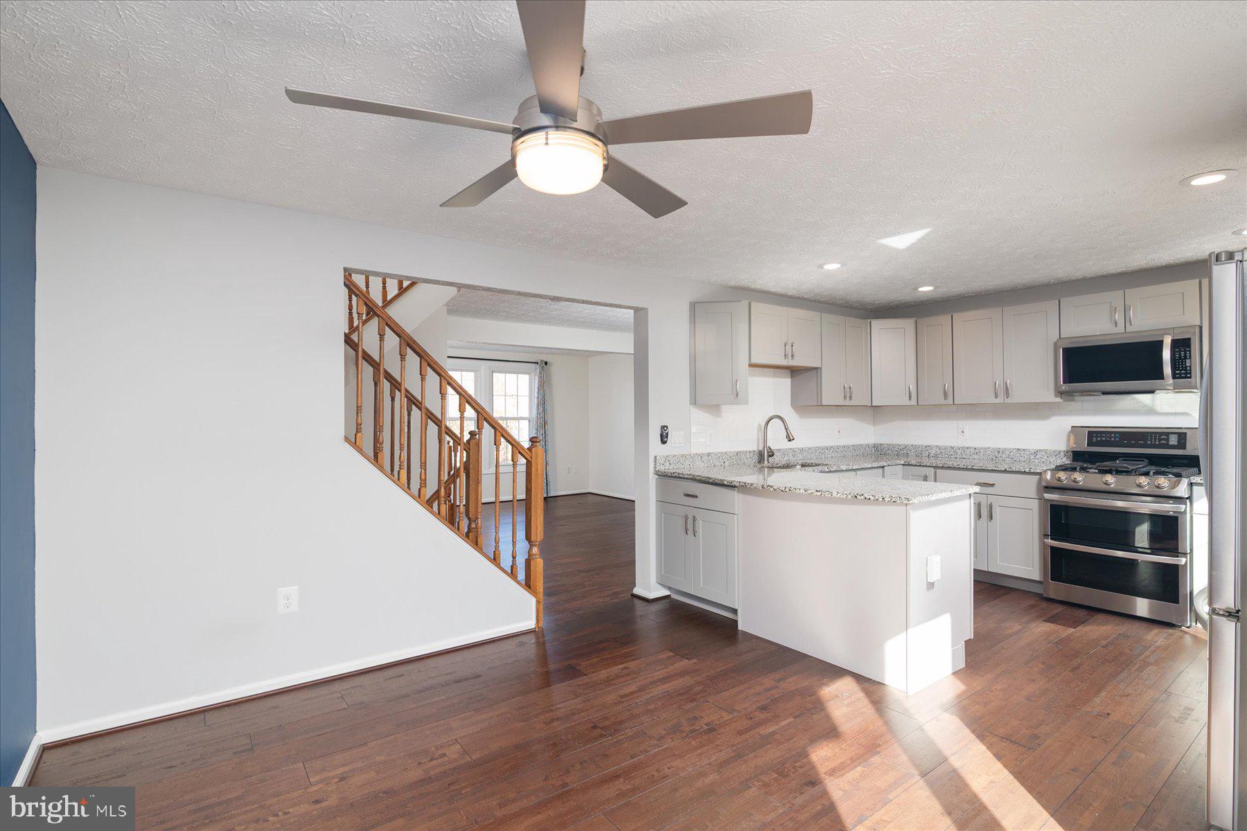 727 Dayspring Drive Odenton, MD 21113 - Photo 10 of 44 a large kitchen with cabinets wooden floor and stainless steel appliances