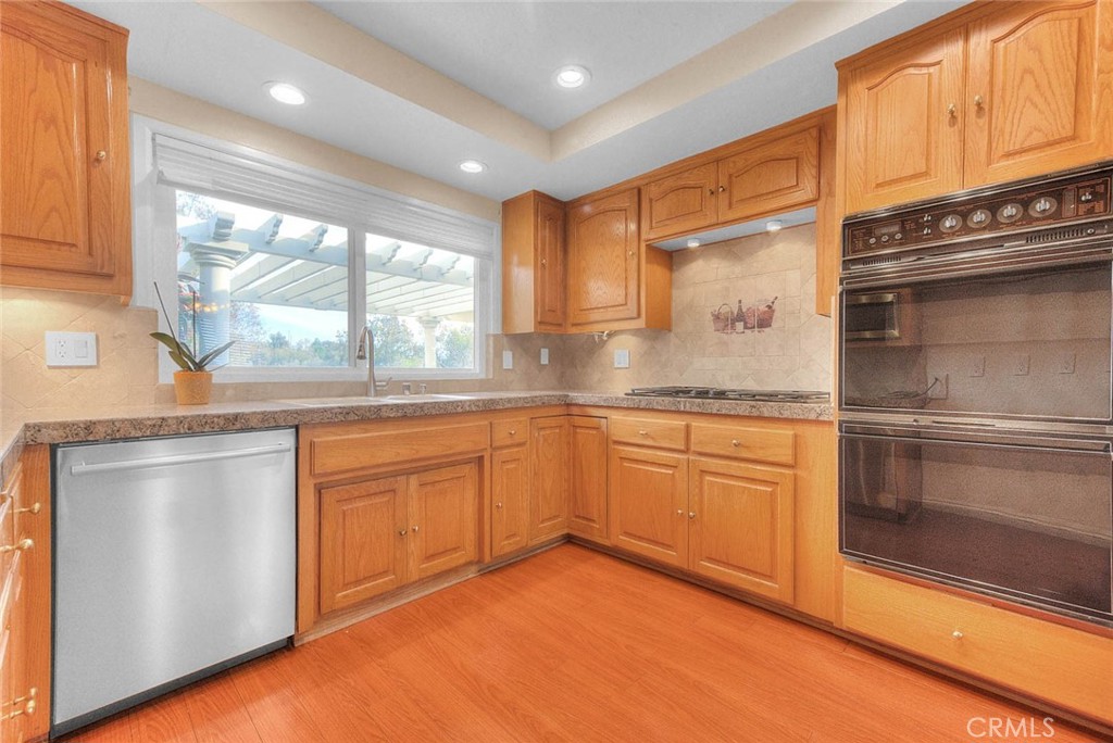 30673 Del Rey Road Temecula, CA 92591 - Photo 19 of 47 Updated Kitchen With Granite Tile Counters, Dishwasher, Microwave Oven, Five Burner Gas Range, Self Cleaning Double Electric Oven. Window Above Double Sink Is Pass Thru To Patio