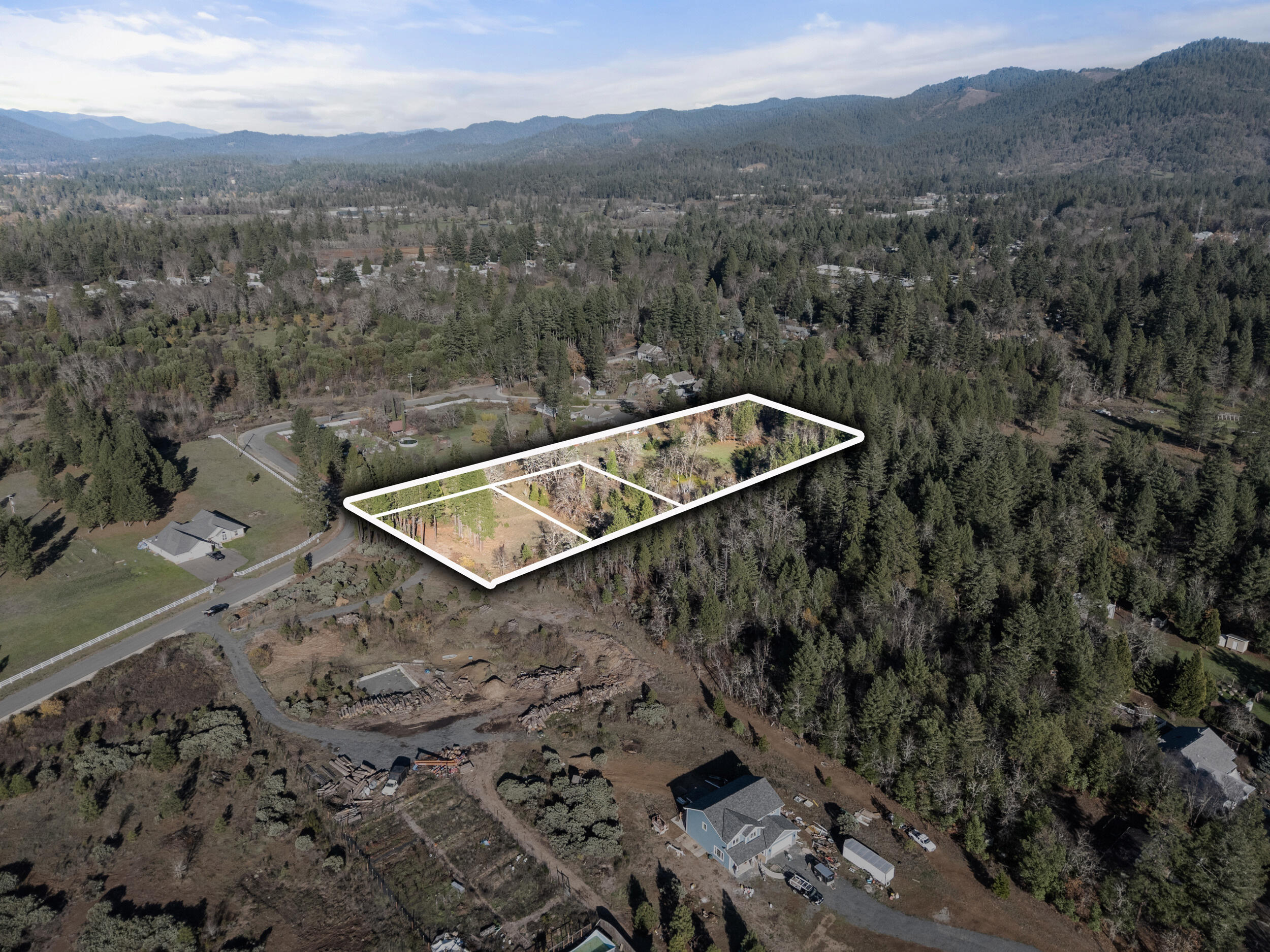681 Daisy Hill Road Cave Junction, OR 97523 - Photo 26 of 26 a view of a forest with a mountain and trees in the background