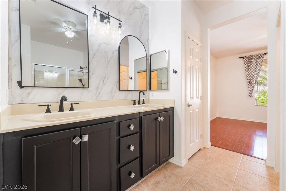 5389 Progresso Street Las Vegas, NV 89135 - Photo 2 of 41 Dual vanity with contrasting dark cabinetry and chic hardware offers a sleek design.