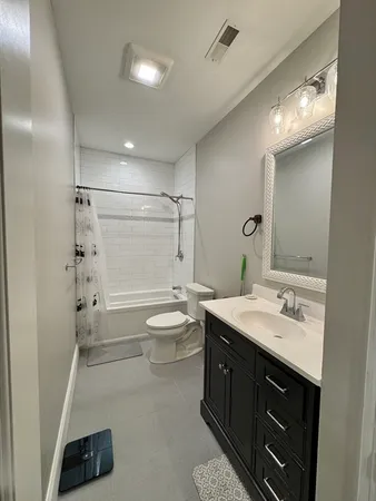 a bathroom with a double vanity sink toilet and shower