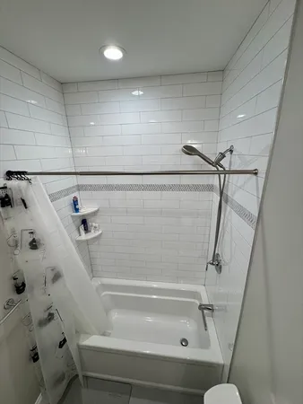 a bathroom with a shower and toilet