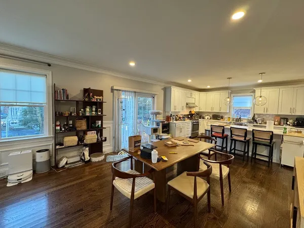 a living room with lots of furniture and view of kitchen