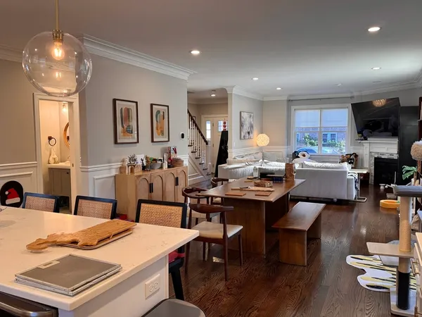 a kitchen with kitchen island granite countertop a sink a stove and wooden cabinets