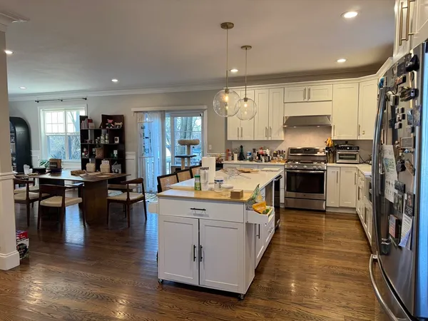 a kitchen with a table chairs stove and kitchen view