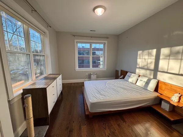 a bedroom with a bed and a large window