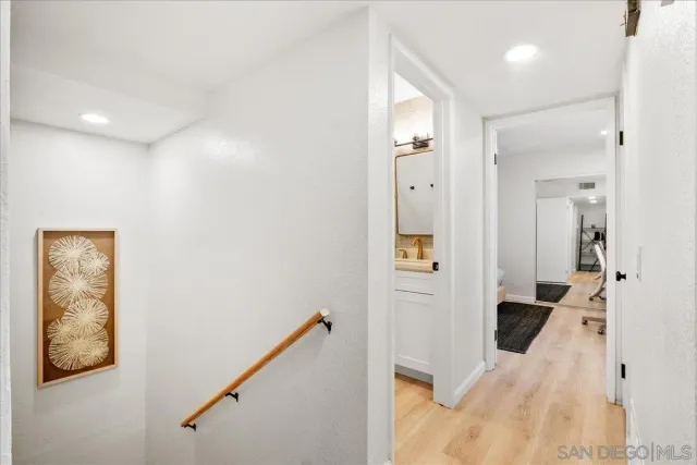 a view of a hallway with wooden floor and entryway