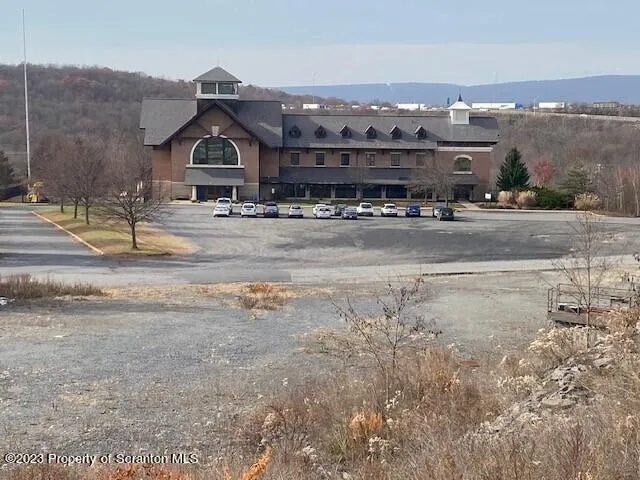 a view of a big house with a mountain in the background