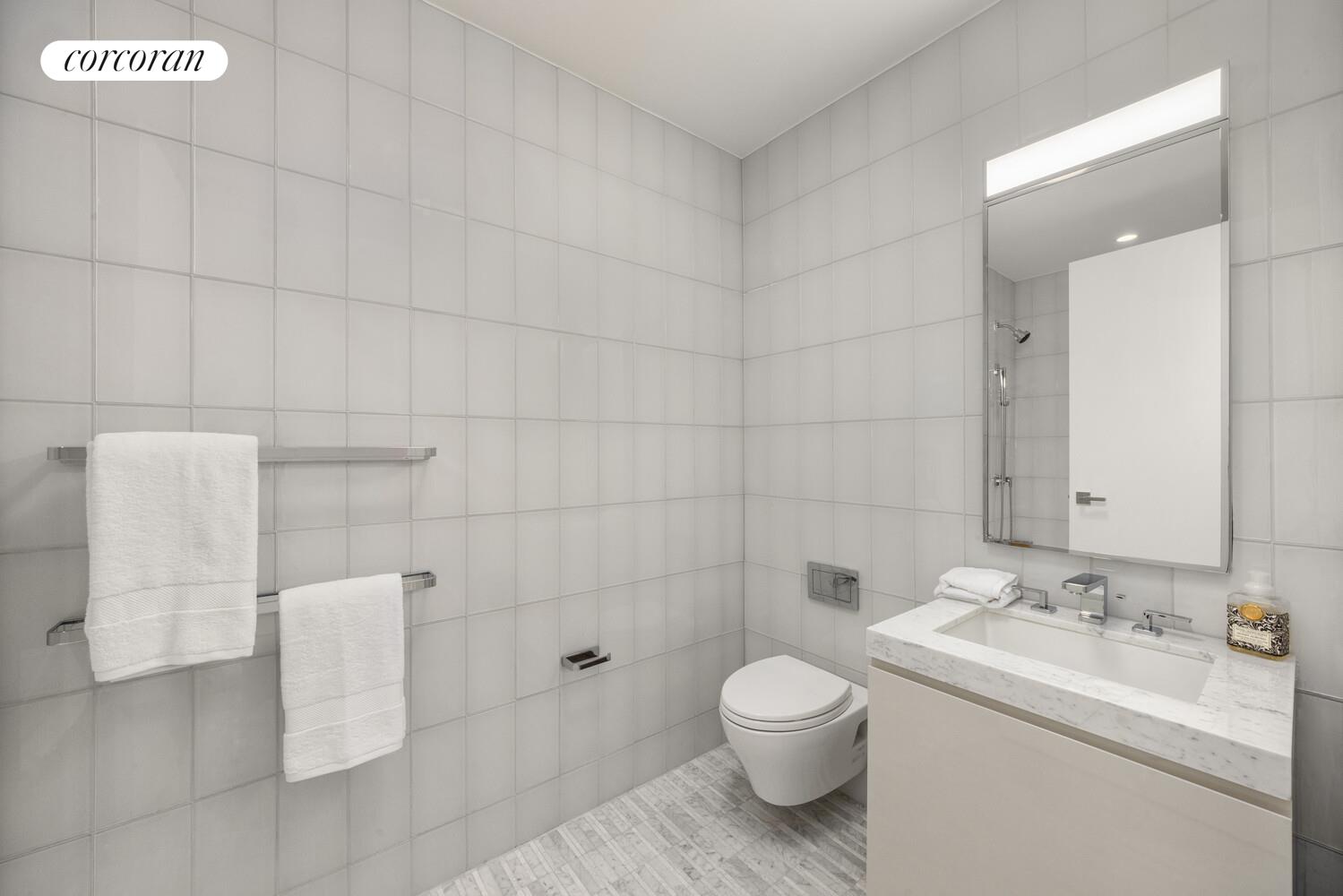 50 West 66th Street, Unit 8F Manhattan, NY 10023 - Photo 9 of 41 a bathroom with a sink a toilet and shower