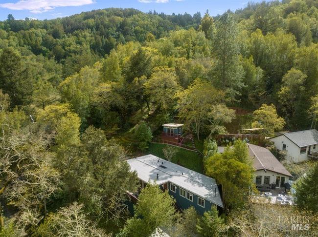 an aerial view of a house with a yard