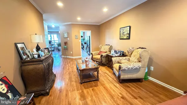 a view of a kitchen with furniture and wooden floor