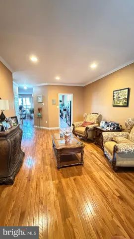 a view of a kitchen with furniture and wooden floor