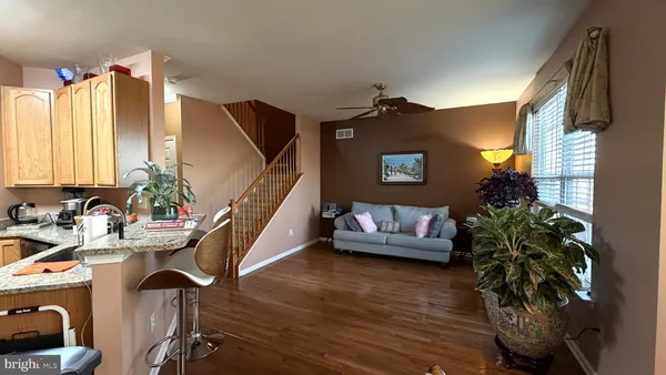 a bedroom with a bed and a dresser next to a window