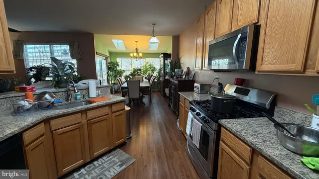 a bedroom with a bed and a dresser next to a window