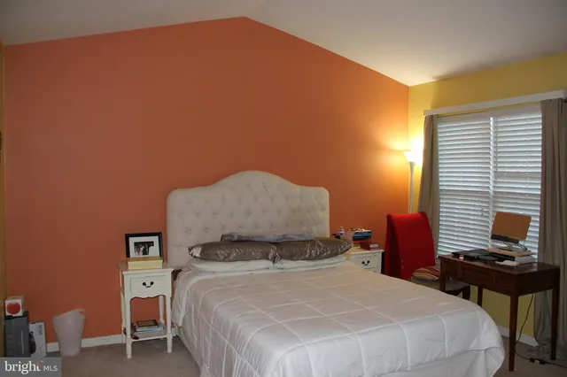 a bed room with a bed and a chandelier