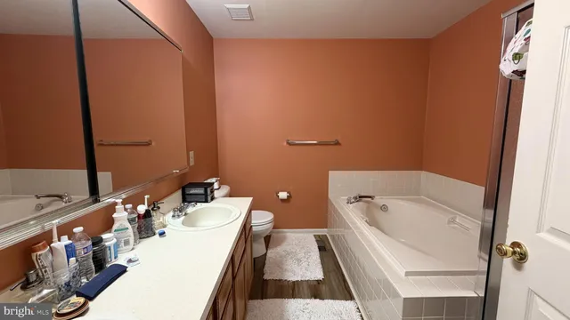 an empty room with wooden floor and closet