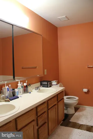 a living room with a flat screen tv a lamp and a window