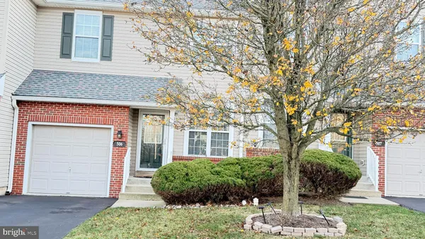 a view of a street with a building and trees