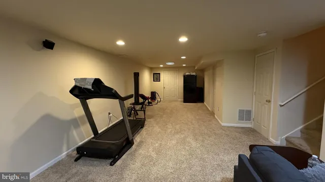 a view of a hallway with furniture and a livingroom view