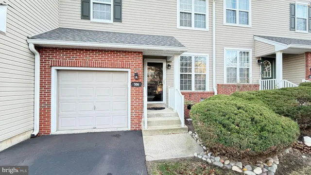 a view of a street with a building and trees
