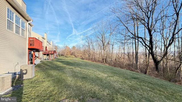 a bedroom with a bed and a flat tv screen on dresser