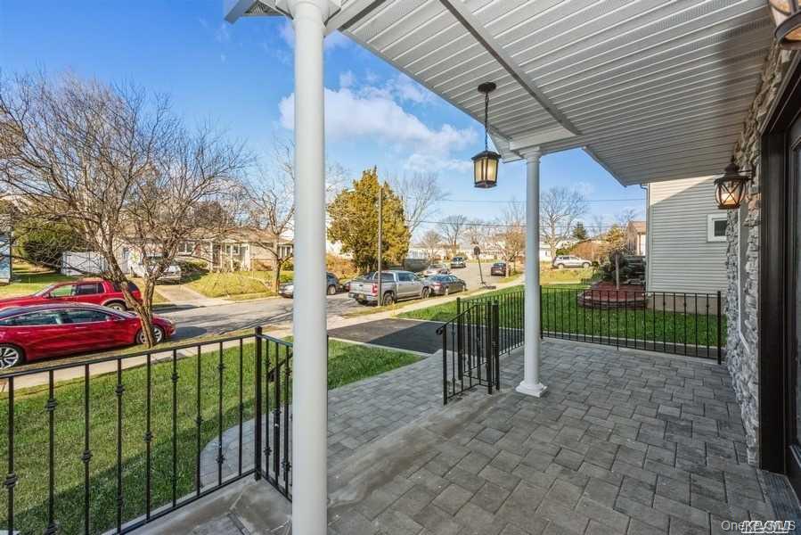 Covered porch featuring a yard and a residential view