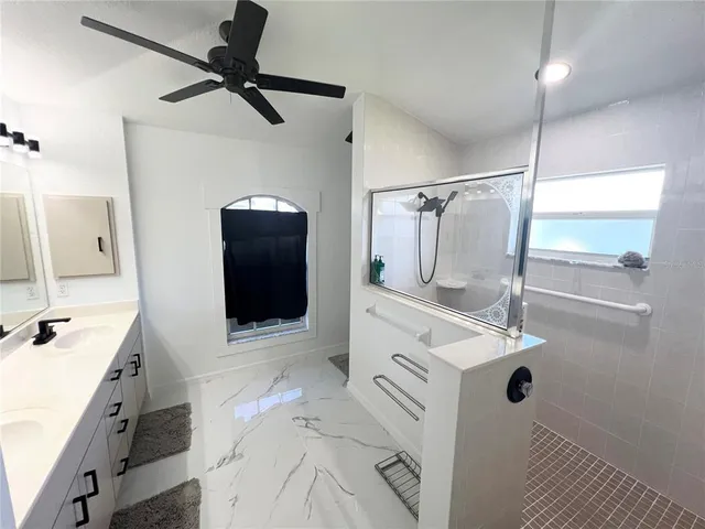 a bathroom with a sink mirror and shower