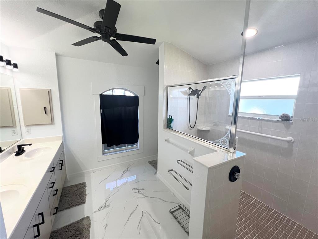 255 Medalist Road Rotonda West, FL 33947 - Photo 11 of 21 a bathroom with a sink mirror and shower