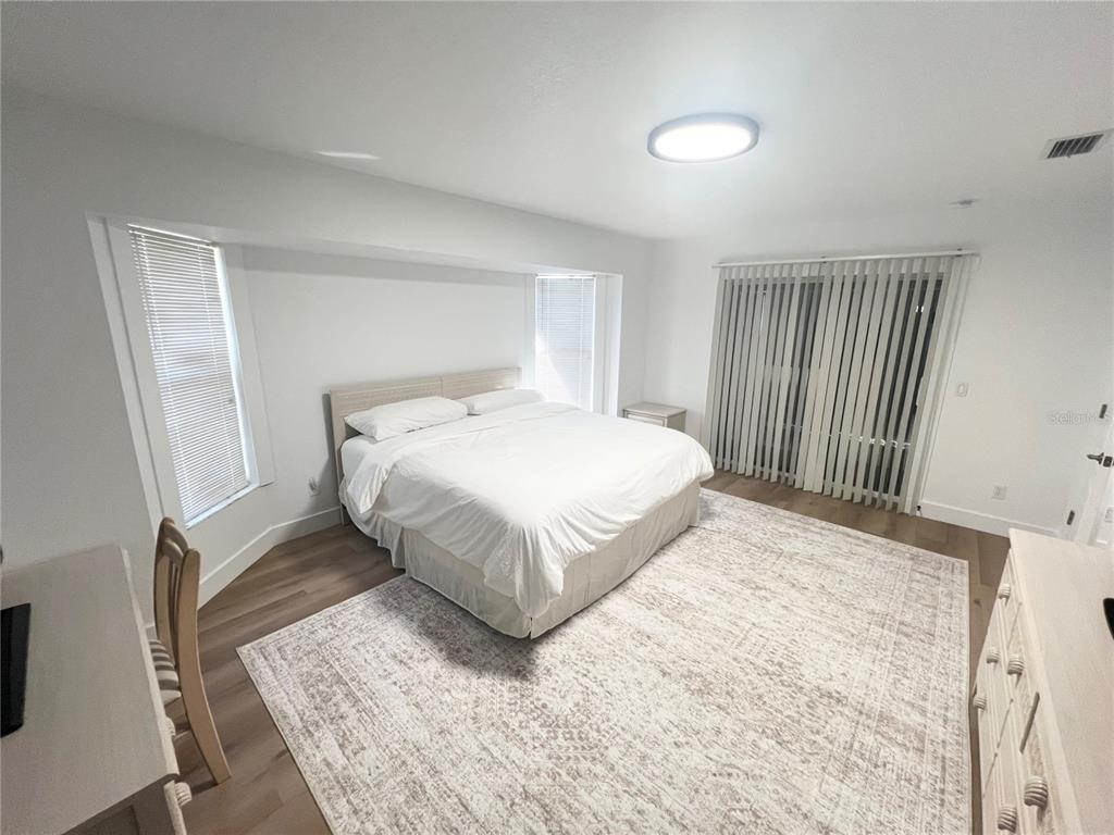 255 Medalist Road Rotonda West, FL 33947 - Photo 12 of 21 a bedroom with a bed and wooden floor