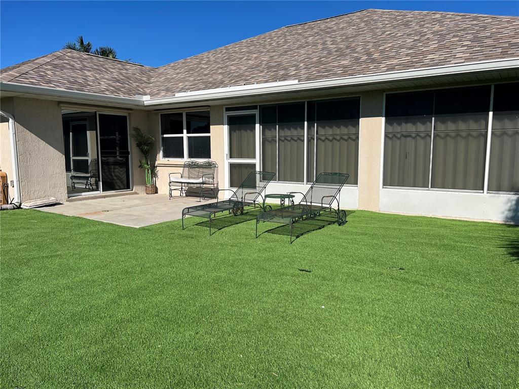 255 Medalist Road Rotonda West, FL 33947 - Photo 17 of 21 a backyard of a house with table and chairs