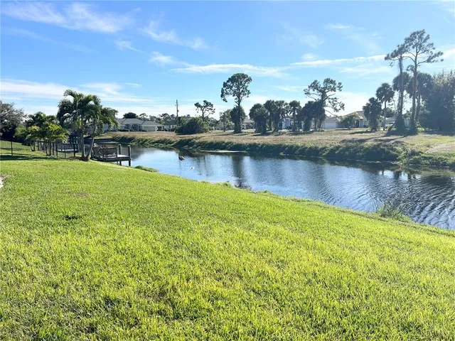 a view of a lake with houses in the back