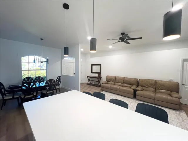 a living room with furniture a chandelier and a flat screen tv