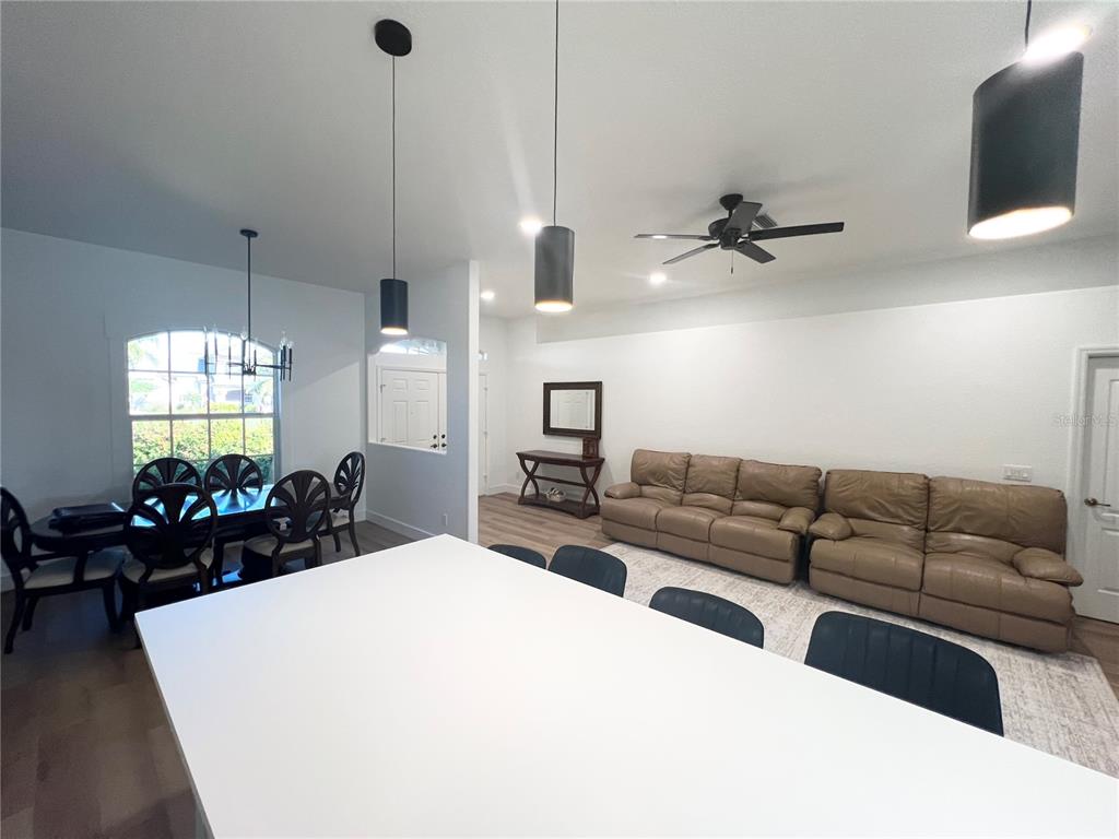 255 Medalist Road Rotonda West, FL 33947 - Photo 4 of 21 a living room with furniture a chandelier and a flat screen tv