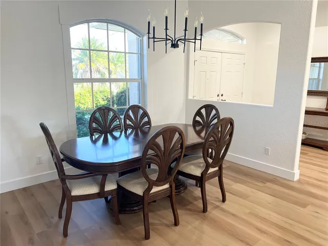 a view of a dining room with furniture window and wooden floor