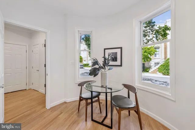 a view of a dining room with furniture window and wooden floor