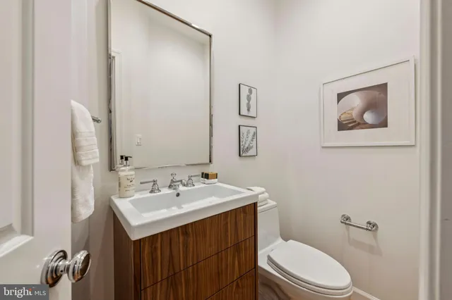 a bathroom with a toilet a sink and mirror