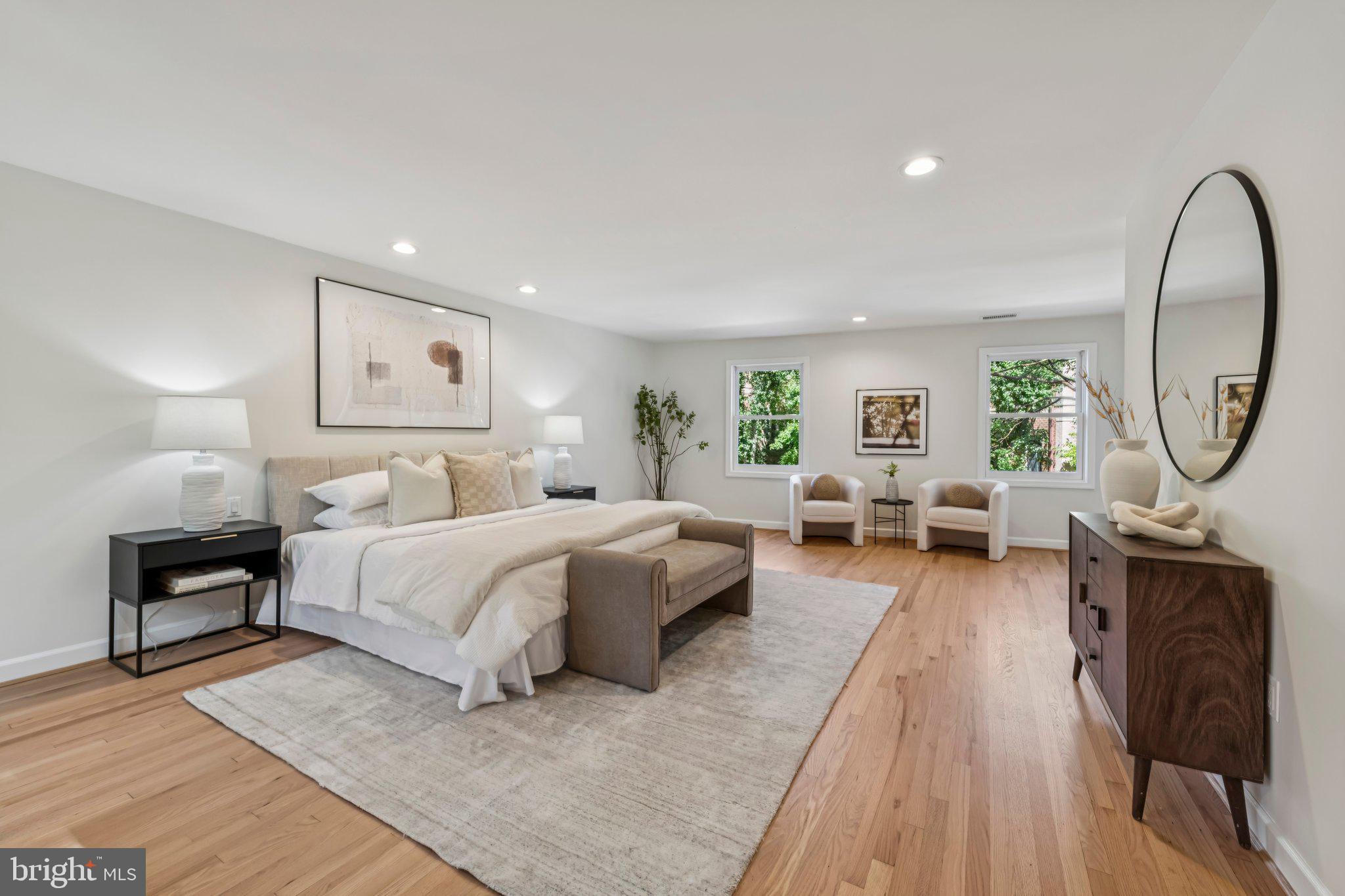 4730 Foxhall Crescent Northwest Washington, DC 20007 - Photo 17 of 37 a spacious bedroom with a bed a mirror and a large window