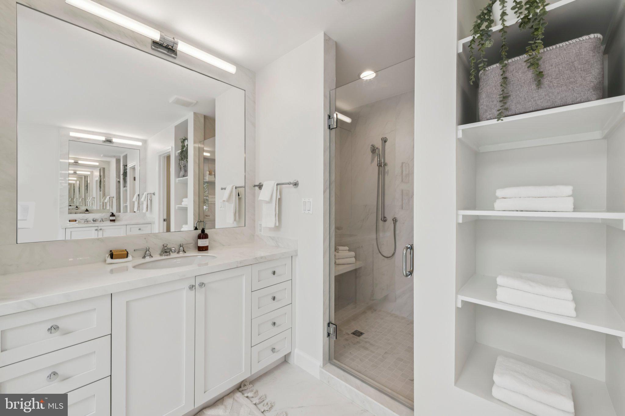 4730 Foxhall Crescent Northwest Washington, DC 20007 - Photo 20 of 37 a spacious bathroom with a shower sink and mirror