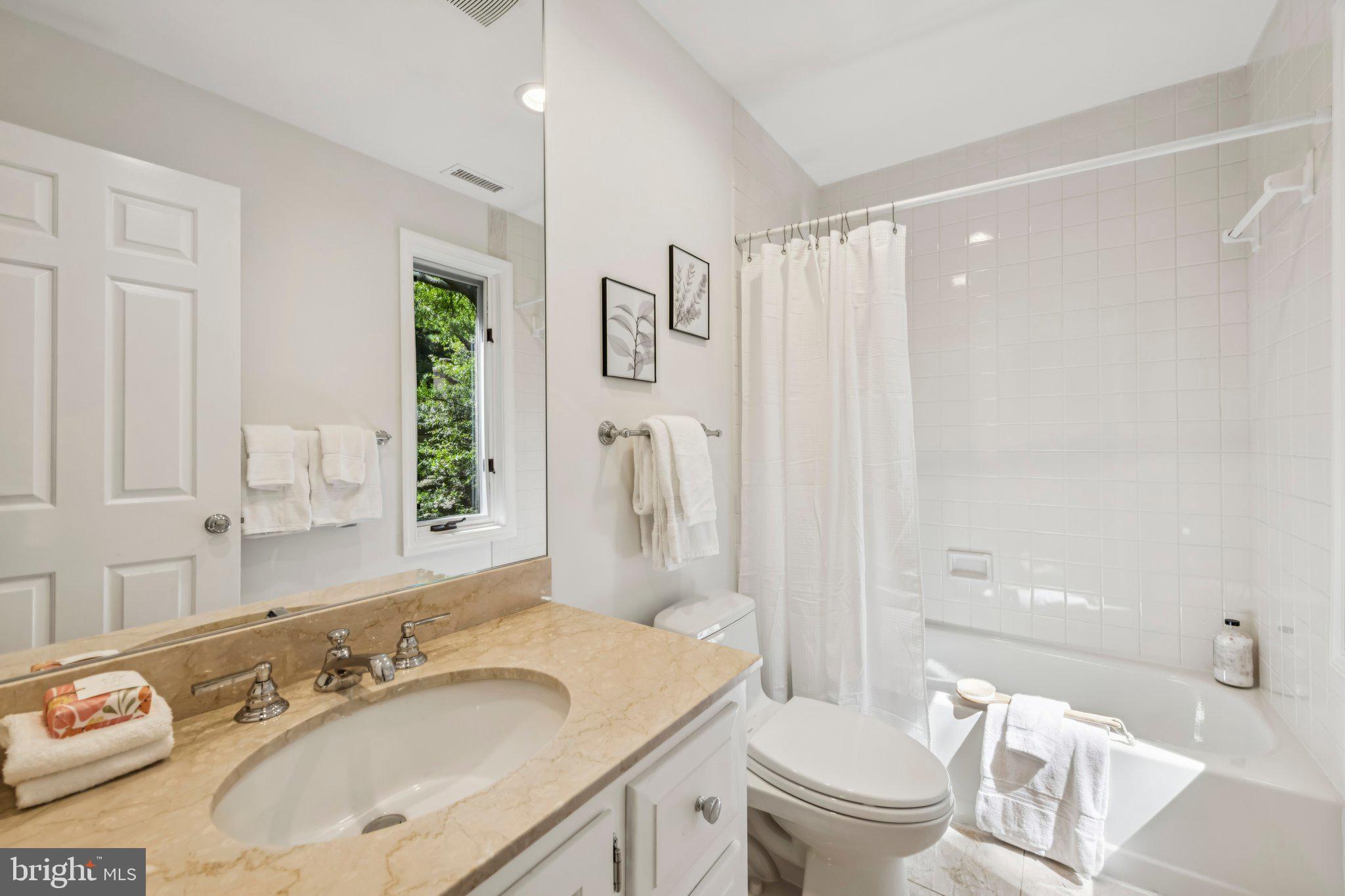 4730 Foxhall Crescent Northwest Washington, DC 20007 - Photo 25 of 37 a bathroom with a granite countertop sink toilet and shower