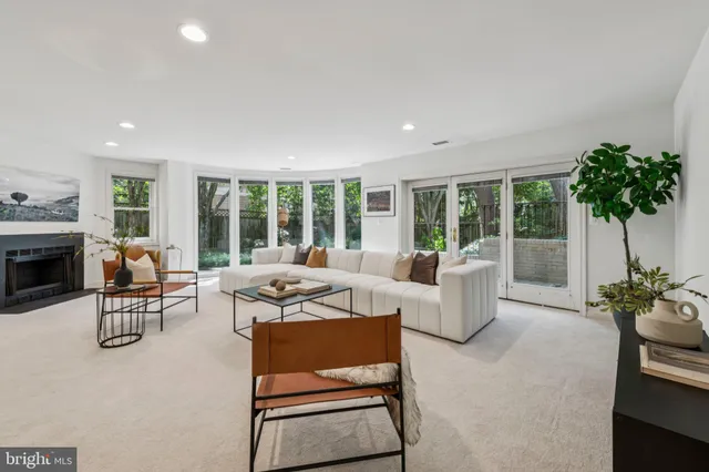 a living room with furniture and a floor to ceiling window
