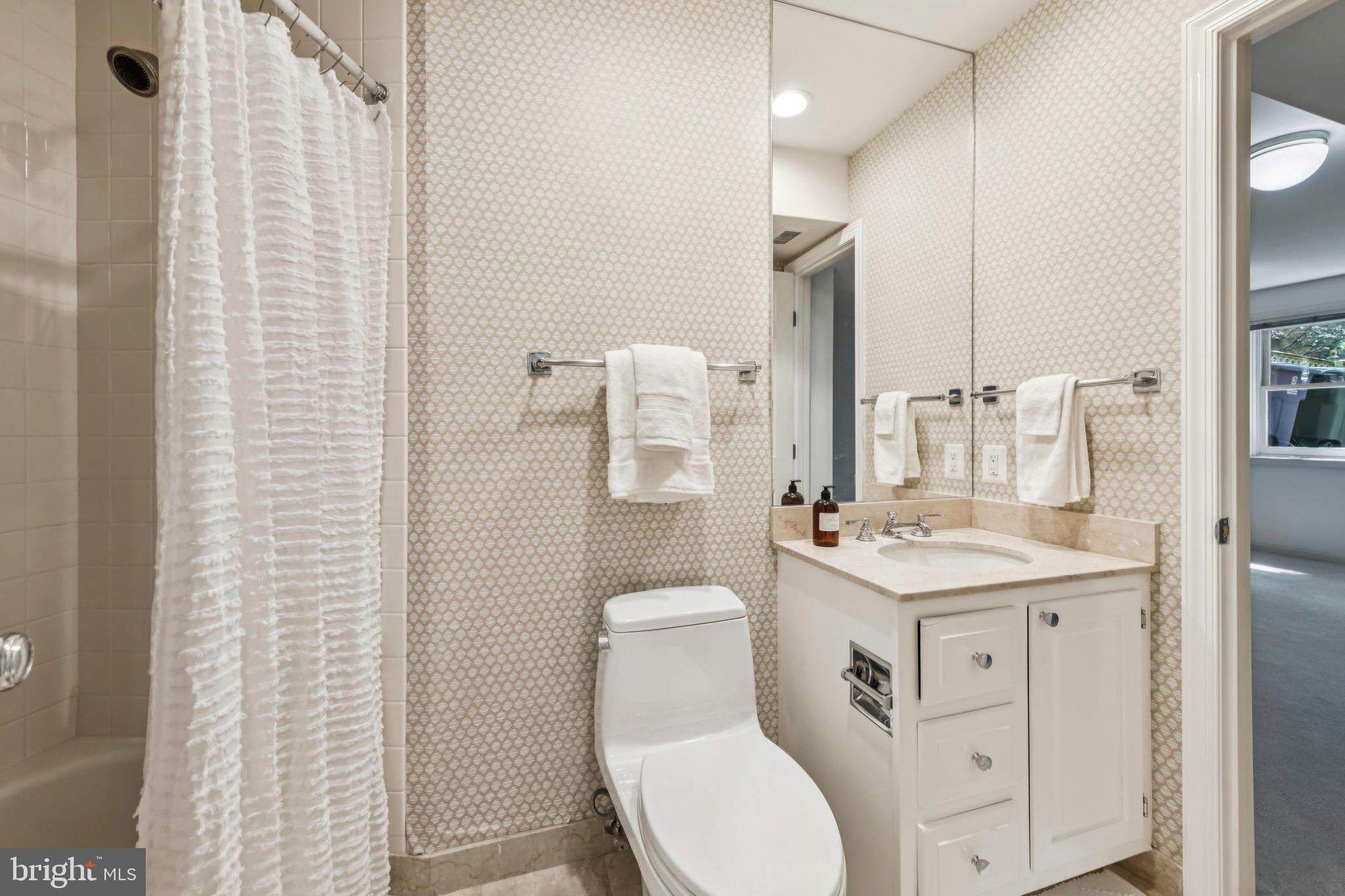 4730 Foxhall Crescent Northwest Washington, DC 20007 - Photo 30 of 37 a bathroom with a toilet sink and mirror